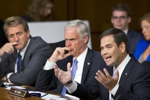 Senate Foreign Relations Committee member Sen. Marco Rubio, R-Fla., joined by fellow committee members, Sen. Ron Johnson, R-Wis., center, and Sen. Jeff Flake, R-Ariz