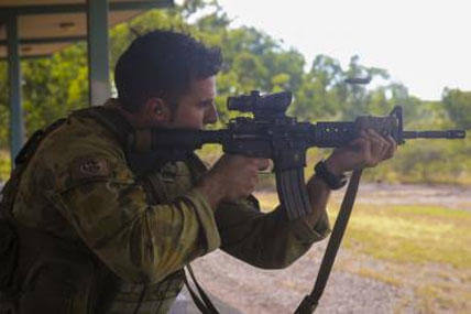 Capt. Christian Difabio, commanding officer of Logistics Company, 5th Battalion Royal Australian Regiment, fires the M4 Carbine aboard Robertson Barracks, April 15, 2014.