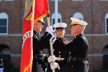 Gen. James F. Amos, the 35th Commandant of the Marine Corps, passes the colors to Gen. Joseph F. Dunford, Jr., during the change of command and subsequent retirement ceremony Oct. 17, 2014 at Marine Barracks Washington, D.C.