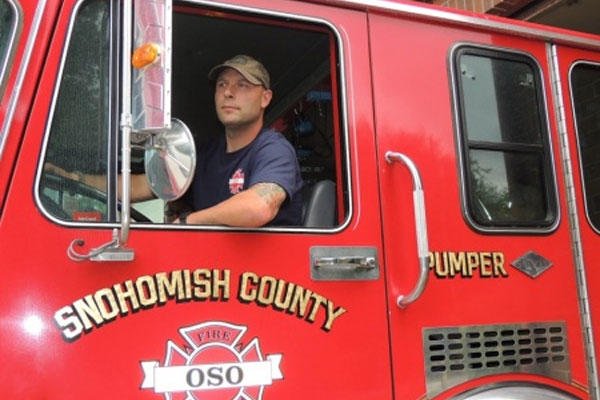 U.S. Coast Guard reservist Petty Officer 1st Class Ryan Olson steers an Oso Fire Department vehicle out of the station in Oso, Wash., Aug. 11, 2012. Olson is the Coast Guard's 2014 Enlisted Person of the Year -- Reserve Component. Courtesy photo  