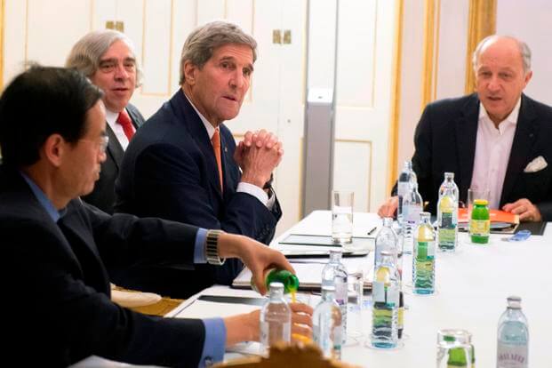 US Secretary of State John Kerry, and French Foreign Minister Laurent Fabius, right, meet at Palais Coburg Hotel, where the Iran nuclear talks are being held, in Vienna, Austria, Tuesday, July 14, 2015.(Joe Klamar/Pool Photo via AP)