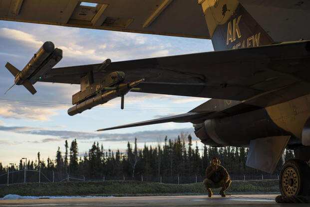Senior Airman Terrence Lawrence, a 354th Aircraft Maintenance Squadron aircraft electrical and environmental systems journeyman, prepares an F-16 Fighting Falcon for a mission, Alaska, Oct. 8, 2015. (Photo: Staff Sgt. Joshua Turner)
