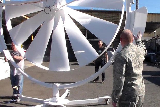Natural Power Concepts personnel and Lt. Col. Scott Fitzner, of the AFRL Materials and Manufacturing Directorate, inspect the spoke wheel medium wind power system. (Courtesy photo/Hawaii Center for Advanced Transportation Technologies)
