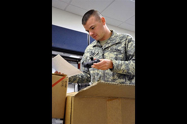 Army Sgt. 1st Class Daniel Aguirre checks incoming equipment against the inventory checklist. (Iowa National Guard/Army Master Sgt. Duff E. McFadden)