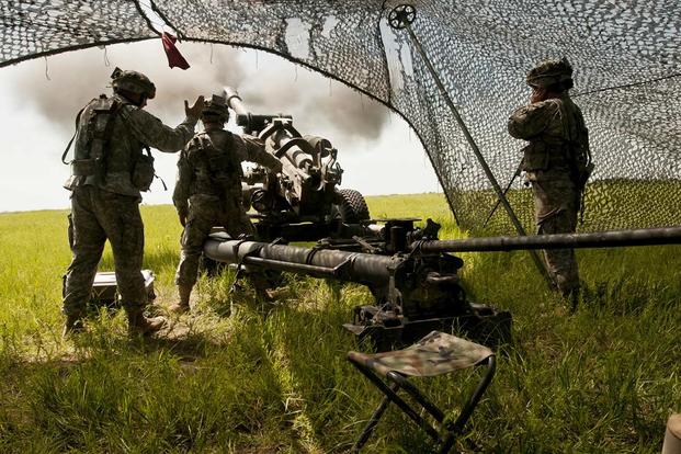 Soldiers of Bravo Battery fire their howitzer during a fire mission coordinated by 1st Lt. Kayla Christopher, the Oklahoma Army National Guard's first qualified female field artillery officer, at Fort Riley, Kansas. (U.S. Army/Sgt. Anthony Jones)