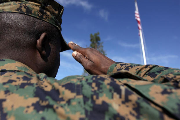 Administrative law noncommissioned officer in charge, Marine Corps Installations West, Camp Pendleton, renders honors to the American flag with a salute, Feb. 10, 2010. (Marine Corps photo by Sgt. Michael T. Knight)
