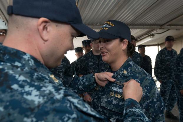 Chief Culinary Specialist Dominique Saavedra, assigned to USS Michigan is pinned with her enlisted submarine qualification during a ceremony at Puget Sound Naval Shipyard (U.S. Navy photo/Kenneth G. Takada)