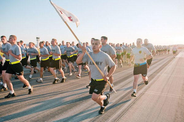 A CAB Soldier charges alongside a formation May 26 during a brigade run at Marshall Army Airfield. (Army photo)
