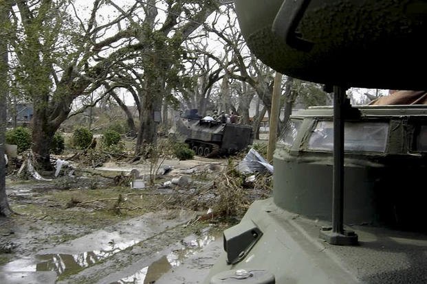 Marines and sailors of a reaction team from Naval Construction Battalion Center ride in amphibious tractors through the ruins of neighborhoods in Southern Mississippi after the devastation of Hurricane Katrina in late August 2005. (Photo By: U.S. Marines)
