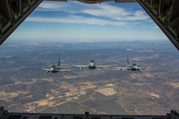 Three Eurofighter Typhoons with the Spanish Air Force escort a U.S. Marine Corps KC-130J Hercules during an aerial refueling mission, Aug. 13, in Spain. (Photo: Staff Sgt. Vitaliy Rusavskiy)
