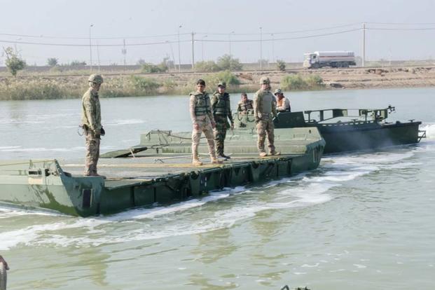 FILE PHOTO -- U.S. Army Soldiers with the 814th Multi-Role Bridging Company and Iraqi engineers with the 15th Iraqi Army Division, drive the MK-II bridge erection boat toward an improved ribbon bridge, Nov. 20, 2015. (Photo by Sgt. Cheryl Cox )