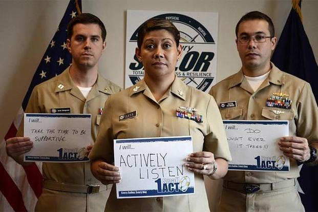 Lt. David Dziengowski, left, Yeoman 1st Class Silvia Raya, and Lt. j.g. Victor Gutierrez, from the Chief of Naval Personnel office, show support as part of Suicide Prevention Month. (US Navy Photo)