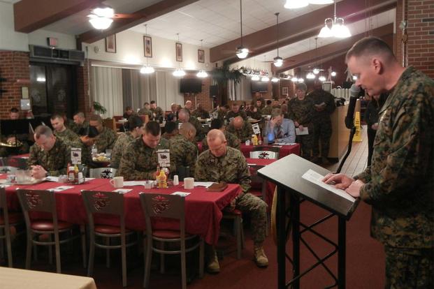 Lt. Cmdr. Robert Burns, Marine and Family Programs Division chaplain, leads a prayer based on the opening lines of the “Our Father” at the National Prayer Breakfast Feb. 12 at Bruce Hall, Quantico. (Marine Photo)