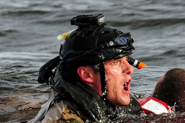 A U.S. Air Force airman from the 23rd Special Tactics Squadron swims to a boat after rescuing a simulated crash victim at Whynnehaven Beach, Fla., April 9, 2013. (U.S. Air Force/Airman 1st Class Christopher Callaway)