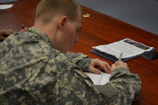 Pfc. Mark A. Jones takes notes during a brief on financial readiness Feb. 27, 2013 in the 2nd Combat Aviation Brigade's Talon Academy classroom on Camp Humphreys. (Photo Credit: Staff Sgt. Aaron P. Duncan)