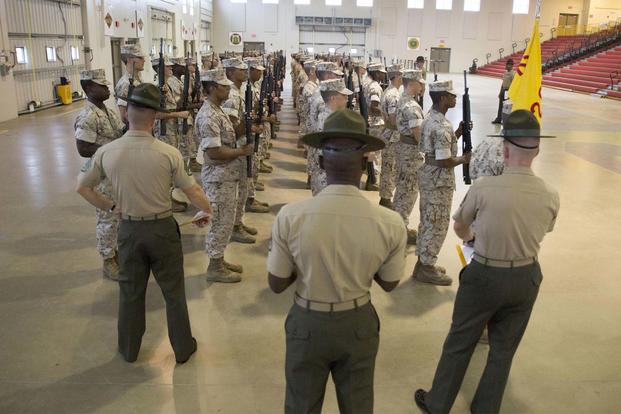 FILE -- Regimental drillmasters critique recruits during an initial drill evaluation Sept. 29, 2014, at Marine Corps Recruit Depot Parris Island, S.C. (Marine Corps/ Cpl. Caitlin Brink)
