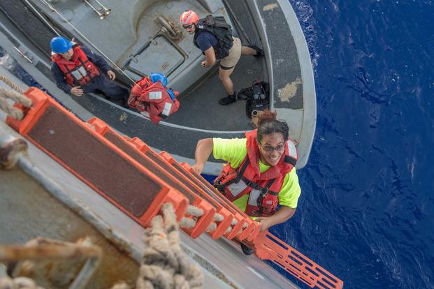 Tasha Fuiaba climbs the accommodation ladder to board the amphibious dock landing ship USS Ashland. (U.S. Navy/Mass Communication Specialist 3rd Class Jonathan Clay)
