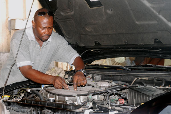 A man conducting engine maintenance.