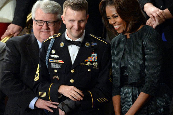Sgt. First Class Cory Remsburg stands with first lady Michelle Obama before President Barack Obama delivered his State of the Union speech during a joint session of Congress on Jan. 28, 2014. (Olivier Douliery/Abaca Press)