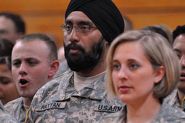 Capt. (Dr.) Tejdeep Singh Rattan, a dentist, joins his graduating class in singing "The Army Goes Rolling Along" during the Basic Officer Leadership Course graduation ceremony, March 22, 2010, at Fort Sam Houston, Texas. Steve Elliott/Army
