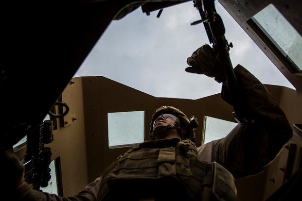 A U.S. Marine with Special Purpose Marine Air Ground Task Force-Crisis Response-Central Command mans the turret gun of a Humvee during a patrol in Al Taqaddum, Iraq, Jan. 1, 2016. (Photo by Rick Hurtado/U.S. Marine Corps)