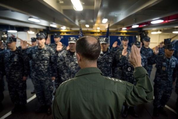 Chief of Naval Operations Navy Adm. John Richardson reenlists sailors aboard the USS John C. Stennis aircraft carrier, on June 5, 2016, in the South China Sea. (Photo by Kenneth Rodriguez Santiago/U.S. Navy)