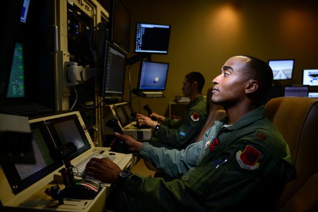 An MQ-9 Reaper pilot of the 432nd Aircraft Maintenance Squadron controls a drone from his work station at Creech Air Force Base, Nev. (US Air Force photo/Vernon Young, Jr.)