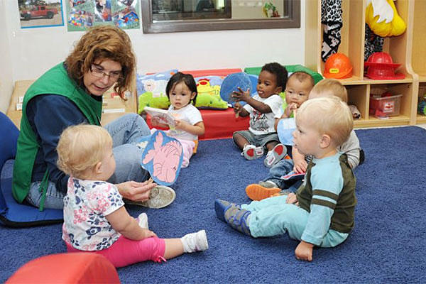 A military daycare worker read to children at a Fort Drum, New York, child development center. Michelle Kennedy/U.S. Army