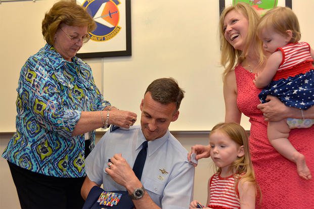 An Air National Guard mom and wife assist during a promotion ceremony.  (Photo: U.S. Air National Guard/Senior Airman Laura Montgomery)