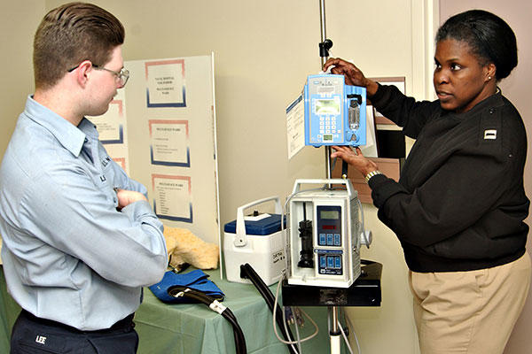Nurse Educator Lt. Melisa Gibbs explains how to operate various medical equipment to Hospitalman Apprentice Jason Lee. (U.S. Navy/Photographer's Mate 2nd Class Michael D. Winter)