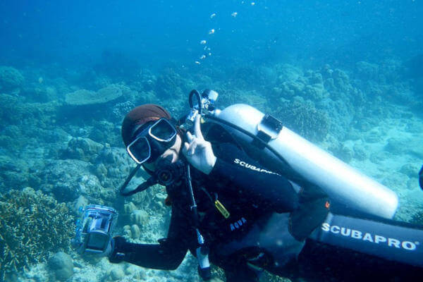 A scuba diver flashing the peace sign