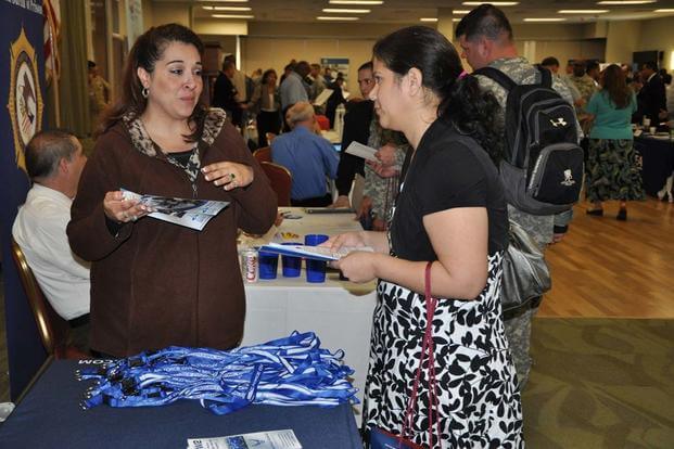 Amy Ruiz, Air Force Personnel Center human resources specialist, provides information about Air Force civilian careers to an attendee during the Hiring Heroes Career Fair at Joint Base San Antonio-Fort Sam. (Air Force photo)