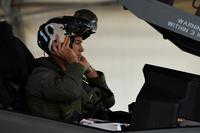 U.S. Navy Lt. Cmdr. Charles Escher, Strike Fighter Squadron (VFA-101) operations officer, dons his helmet prior to flying an Air Force F-35A Dec. 6, 2016, at Eglin Air Force Base, Florida. (U.S. Air Force/ Staff Sgt. Peter Thompson)