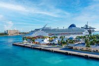 A cruise ship is moored in the Port of Freeport City in the Bahamas. A cruise ship is docked in Freeport, Bahamas