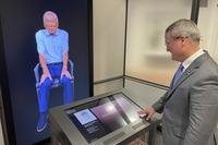 Peter Crean of the National WWII Museum in New Orleans stands at an interactive exhibit