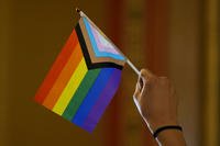 An LGBTQ+ rights supporter holds a flag
