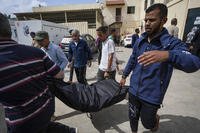 People carry the bodies of Palestinians who were killed in an Israeli airstrike