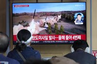 A TV screen shows a file image of North Korea's missile launch during a news program