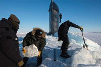 Sailors and civilians, assigned to the Arctic Submarine Lab, clear the ice from the hatch of theUSS Hampton (SSN 767) during Ice Exercise (ICEX) 2016. (US Navy/Tyler Thompson)