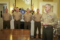 Former Marine Commandant Gen. James F. Amos awards the Navy Marine Corps Commendation Medal to four Marine enlisted aides. Marine Corps photo