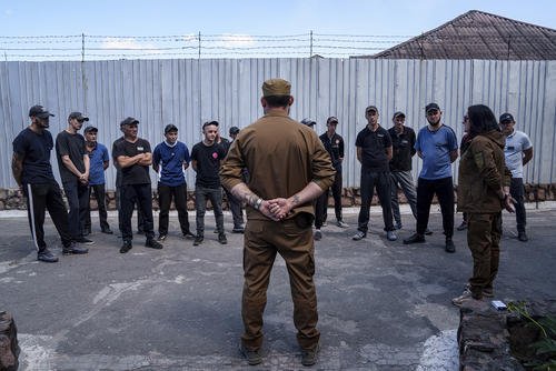 Prisoners listen to a Ukrainian sergeant of the Battalion Arey during an interview in a prison in the Dnipropetrovsk region, Ukraine, Friday, June 21, 2024.