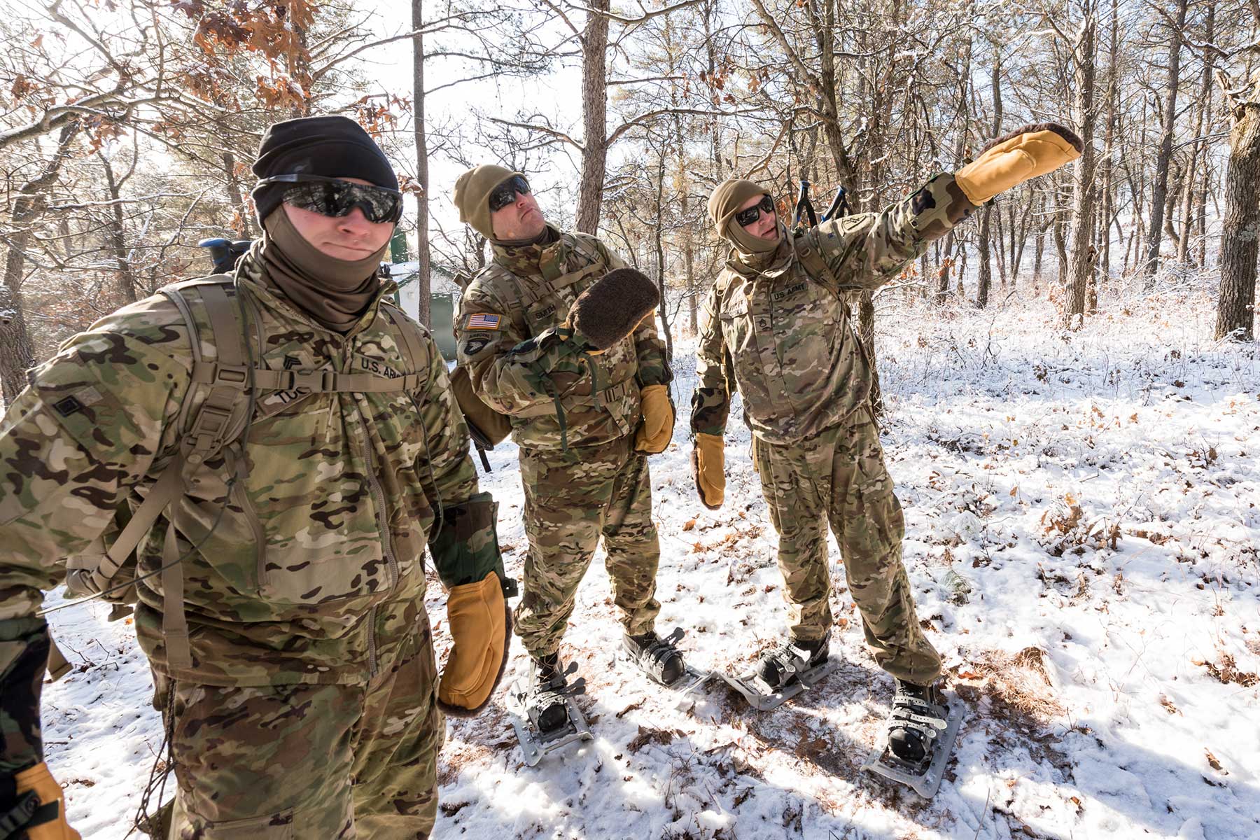 Soldiers and Marines prepare for a cold weather march using snowshoes while at Total Force Training Center Fort McCoy's Cold Weather Operations Course.