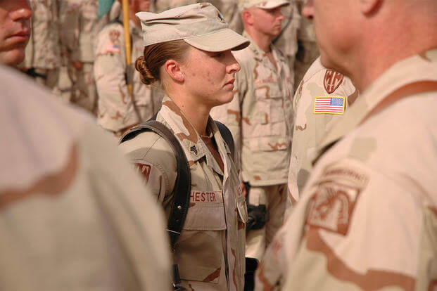 Sgt. Leigh Ann Hester stands at attention before receiving the Silver Star. (U.S. Army/Spc. Jeremy D. Crisp)