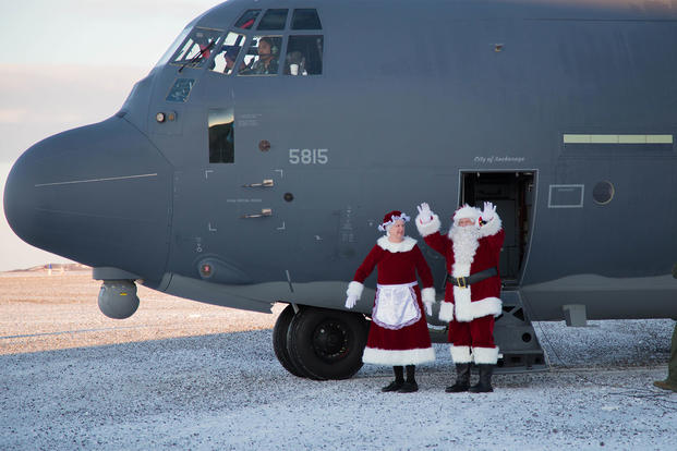 Mr. and Mrs. Santa Claus, travelling with Operation Santa Claus, de-board an HC-130J Combat King II aircraft from the 211th Rescue Squadron, Alaska Air National Guard, after landing in St. Michael, Alaska, Dec. 5, 2017. (U.S. Army National Guard/Marisa Lindsay)