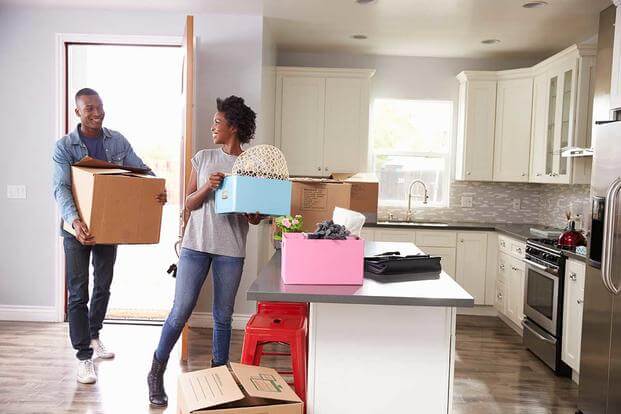 couple with moving boxes in kitchen