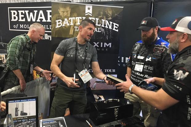 Kris Paronto signs a copy of his book "The Ranger Way" at SHOT Show 2018 in Las Vegas. Hope Hodge Seck/Military.com