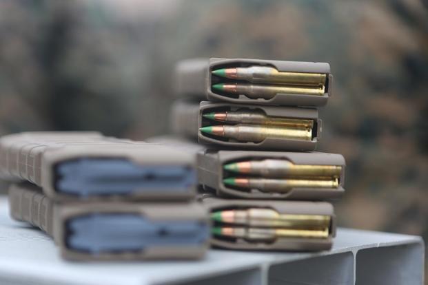 Marines with the 2nd Marine Division load magazines with 5.56mm rounds in preparation for an infantry platoon battle course as part of a deployment for training at Fort Pickett, Va., Feb. 21, 2018. (U.S. Marine Corps Photo by Pfc. Heather Atherton)