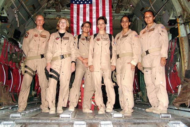 From left to right, Staff Sgt. Josie E. Harshe, flight engineer; Capt. Anita T. Mack, navigator; 1st Lt. Siobhan Couturier, pilot; Capt. Carol J. Mitchell, aircraft commander; and loadmasters Tech. Sgt. Sigrid M. Carrero-Perez and Senior Airman Ci Ci Alonzo, pause in the cargo bay of their C-130 for a group photo following their historic flight. (U.S. Air Force/ Tech. Sgt. Louis Vega)