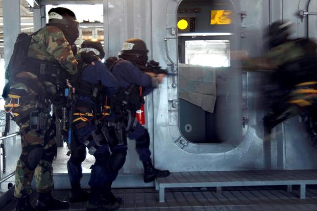 Students of the Ship's Reaction Force Advanced Class enter and secure the bridge during a shipboard force-protection simulation at the Center for Security Forces Pearl Harbor Learning. Simulations such as these educate and train for real-world situations. (U.S. Navy/Mass Communication Specialist 2nd Class Daniel Cleary)