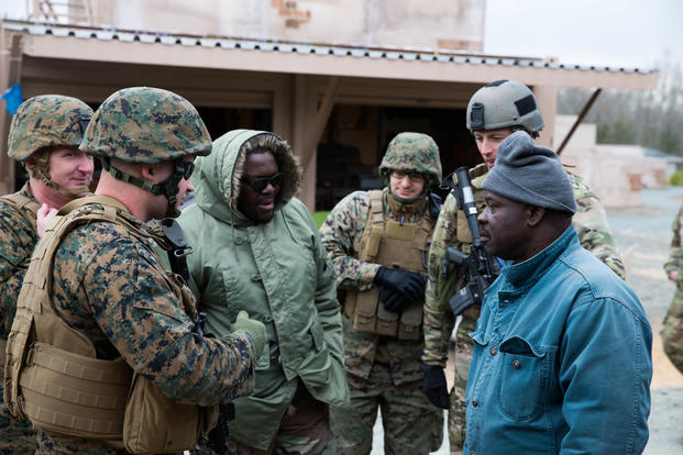 U.S. Marines and a U.S. Soldier practice village engagement in a MOUT Town during the Combine Unit Exercise (CUX) at Camp Upshur, Quantico VA., March 16, 2018. The CUX is a training exercise that allows Marines, sister services, and allied partners to be trained on the integration of Information Related Capabilities for future missions and operations. (U.S. Marine Corps photo/Robert Gonzales)